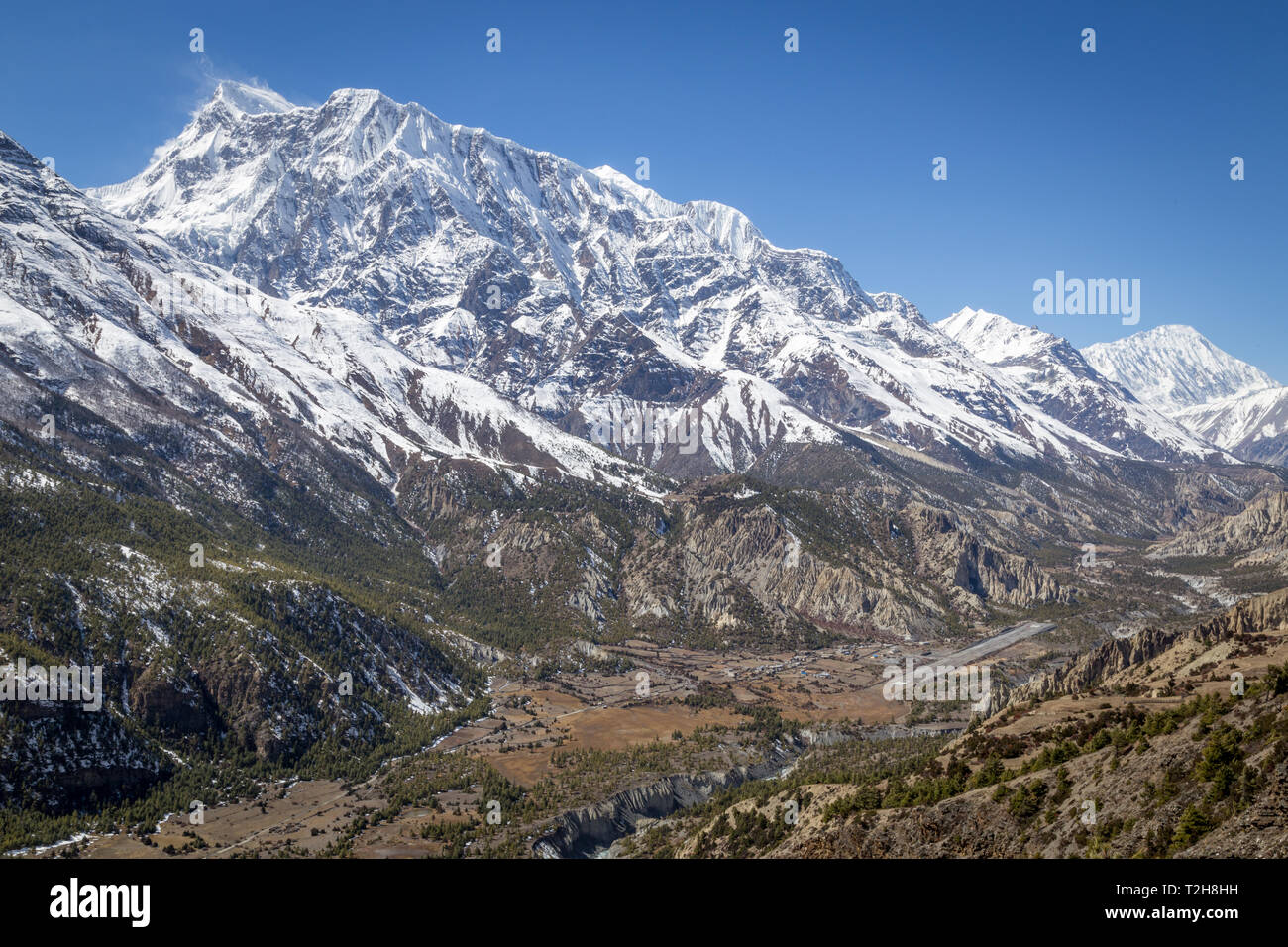 Manang, Nepal - October 28, 2014: View of a valley with the village Manang and the airport in the Annanpurna Conservation Area. Stock Photo