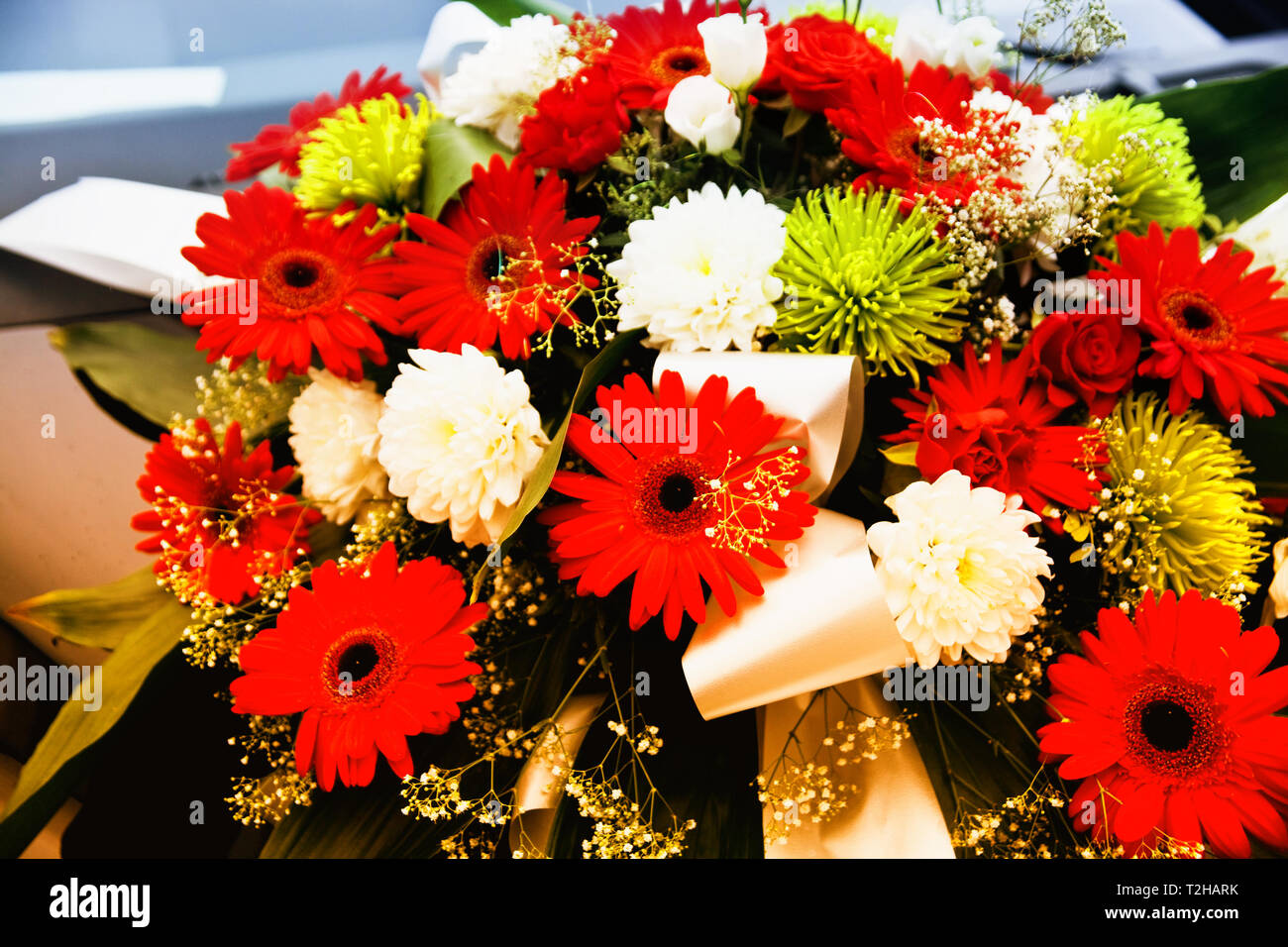 A flower bouquet for the wedding on the hood of a car. Stock Photo