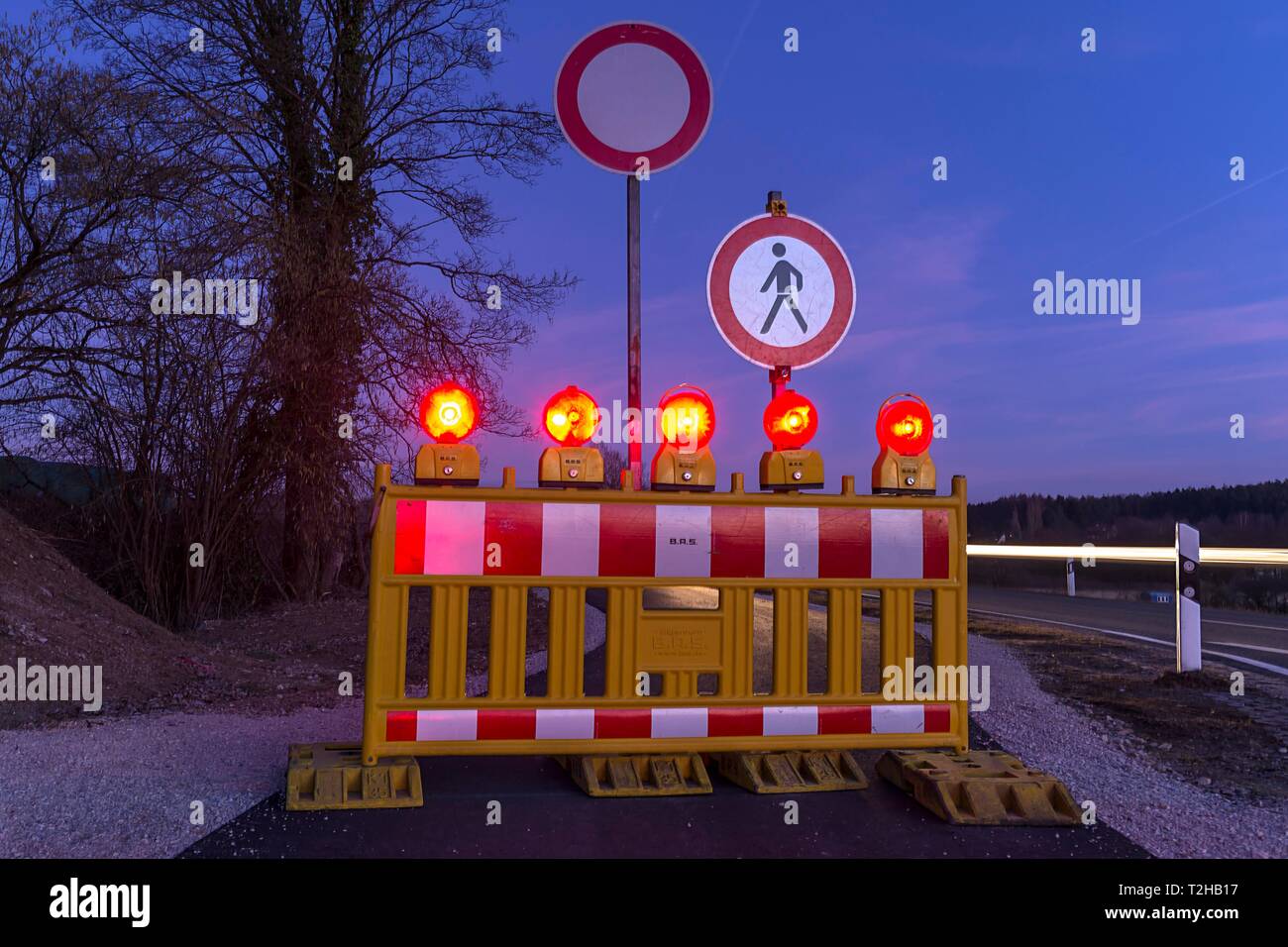 Illuminated road block on bicycle path, footpath at dusk, Middle Franconia, Bavaria, Germany Stock Photo
