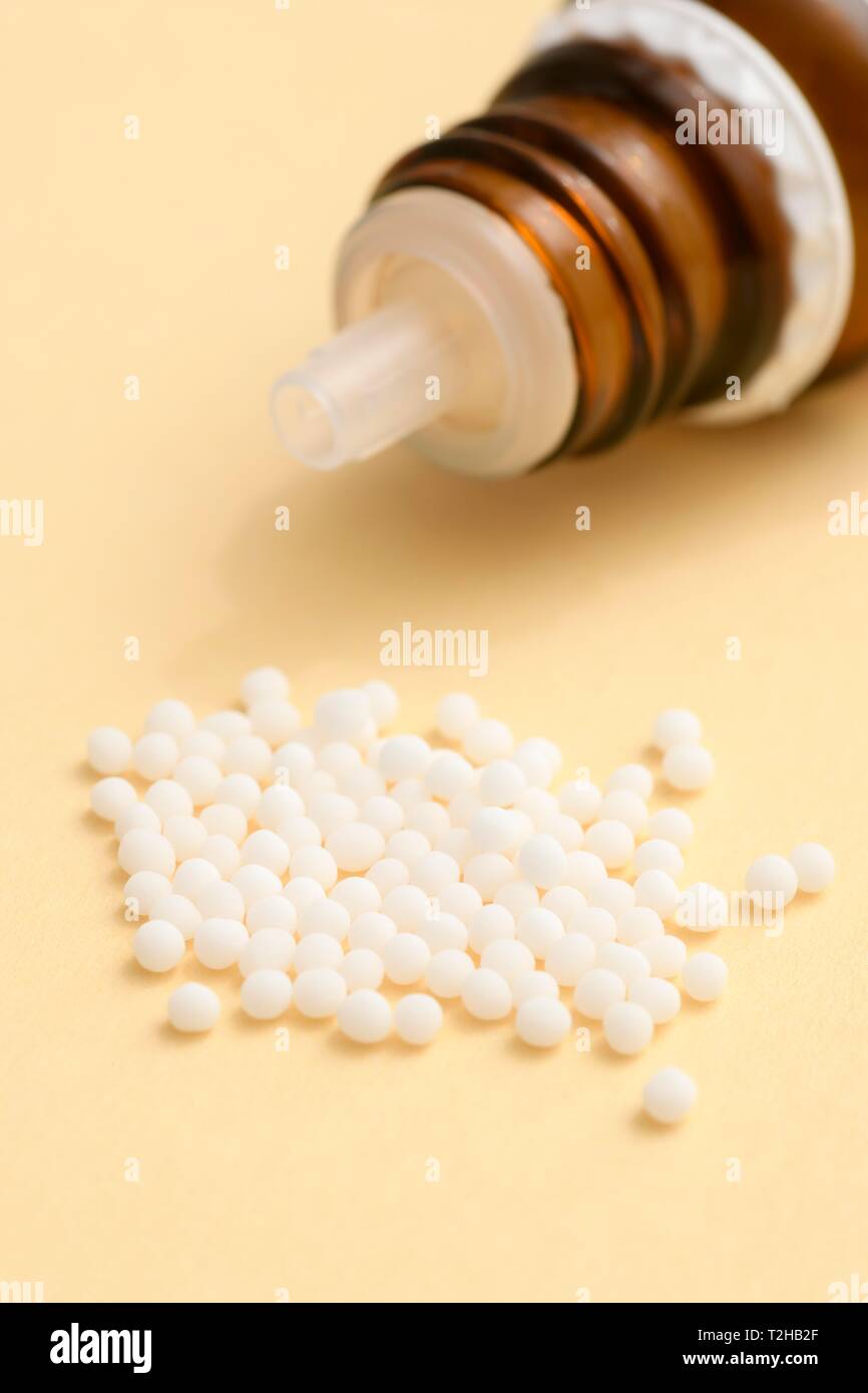 Globules in a pile with bottle, Homeopathy, Germany Stock Photo