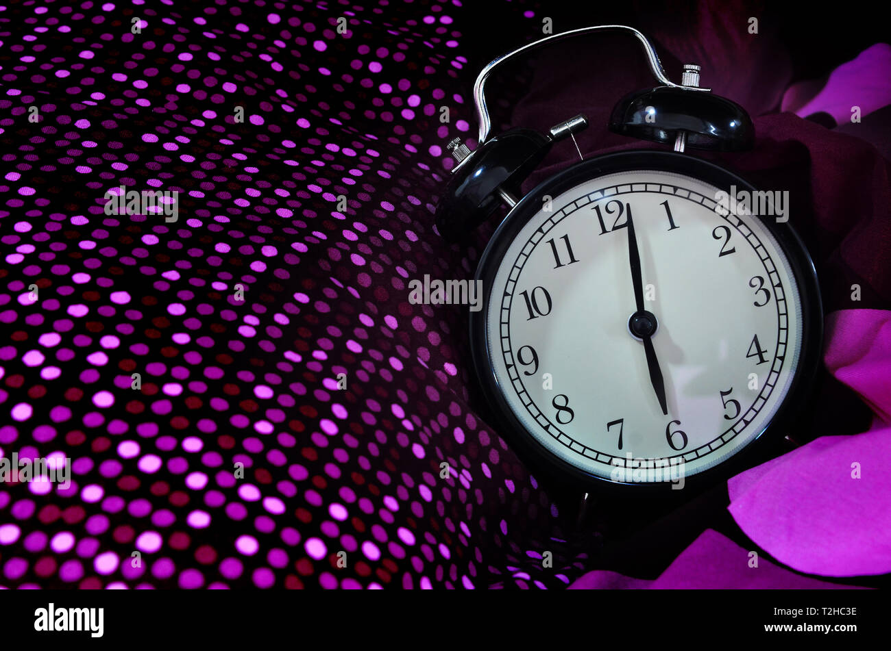 Retro alarm clock in the morning on bed sheet Stock Photo - Alamy