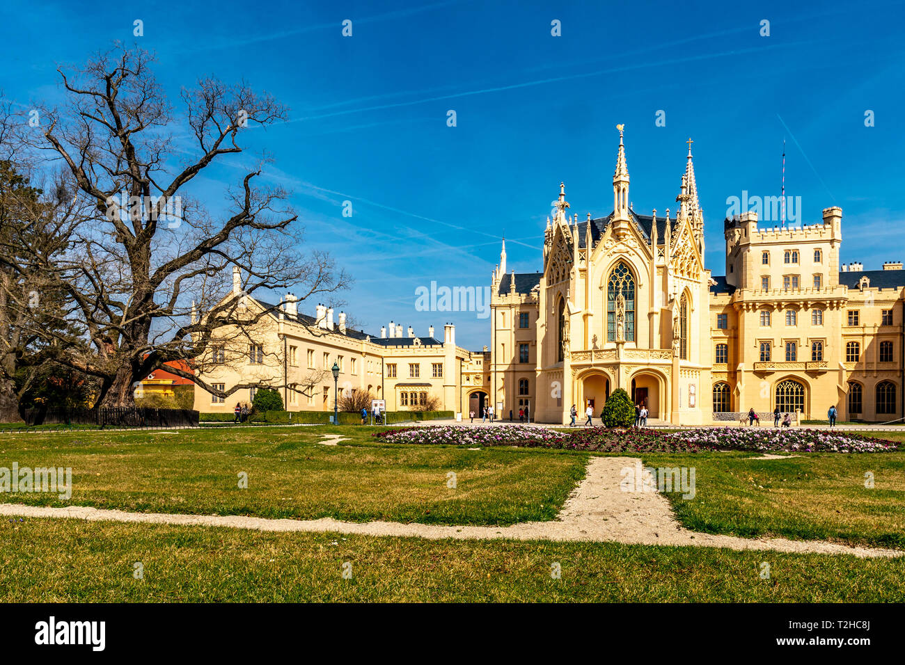 Lednice Valtice Cultural Landscape Area Complex Castle Front View with Flowers Walking People and Picturesque Blue Sky in Spring Stock Photo