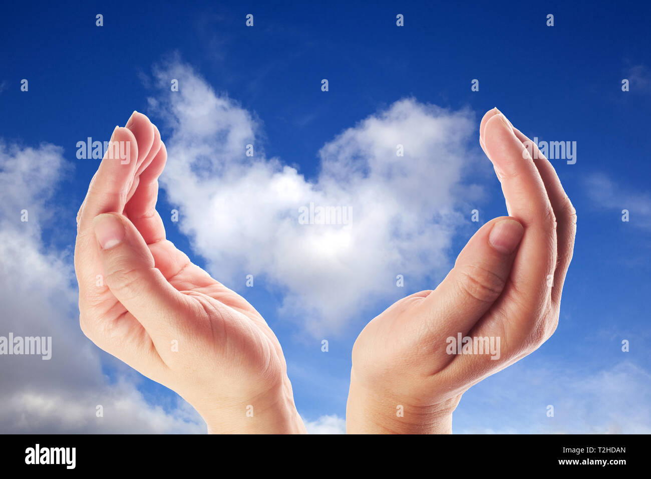 Hand holding the cloud for concept world wide data sharing and communication. Blue sky Stock Photo