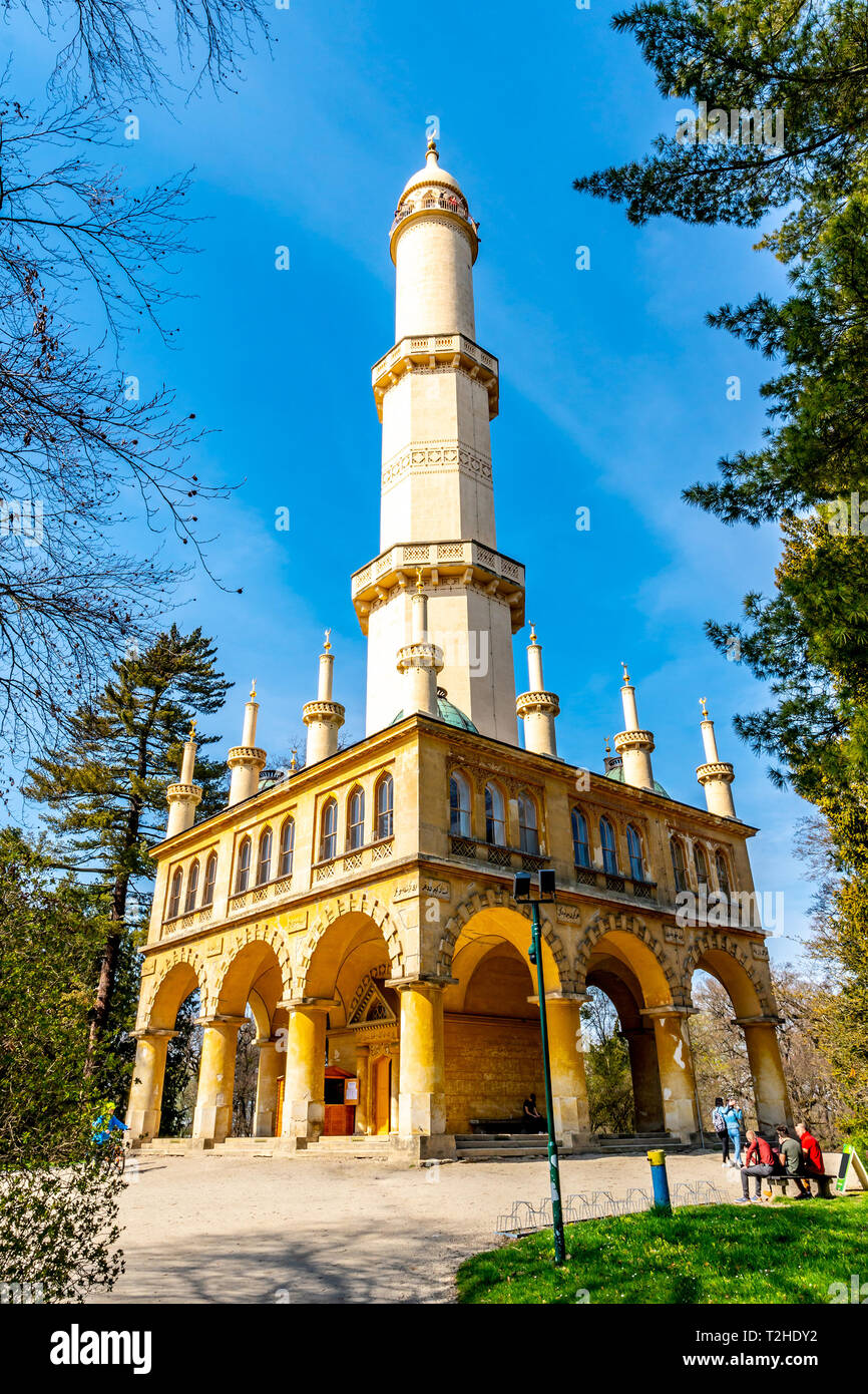 Lednice Valtice Cultural Landscape Area Complex Garden Minaret Side View with People Sitting at Bench and Picturesque Blue Sky in Spring Stock Photo