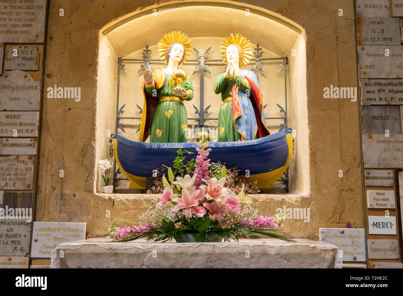 Saintes-Maries-de-la-Mer: The Marys on a barge representing Mary Salome and Mary Jacob in their chapel surrounded by ex-voto Stock Photo