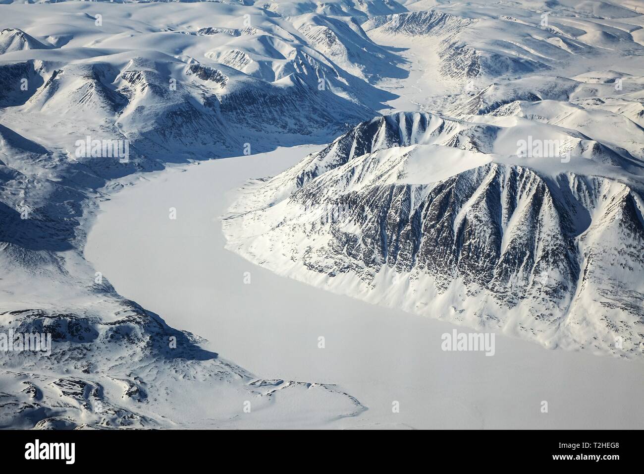 Arctic landscape, snow-covered mountain landscape with glacier, King Christian X Land, Greenland Stock Photo