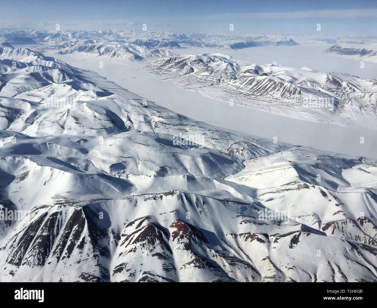 Arctic landscape, snow-covered mountain landscape with glacier, King Christian X Land, Greenland Stock Photo