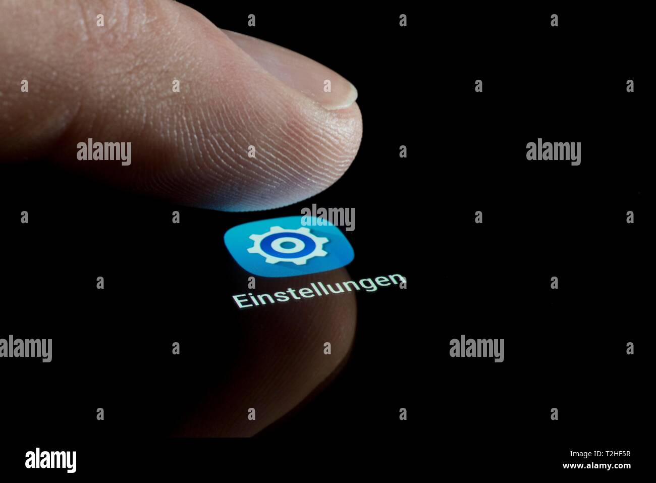 Settings App icon on a display, with finger, mobile phone, smartphone, tablet, Germany Stock Photo
