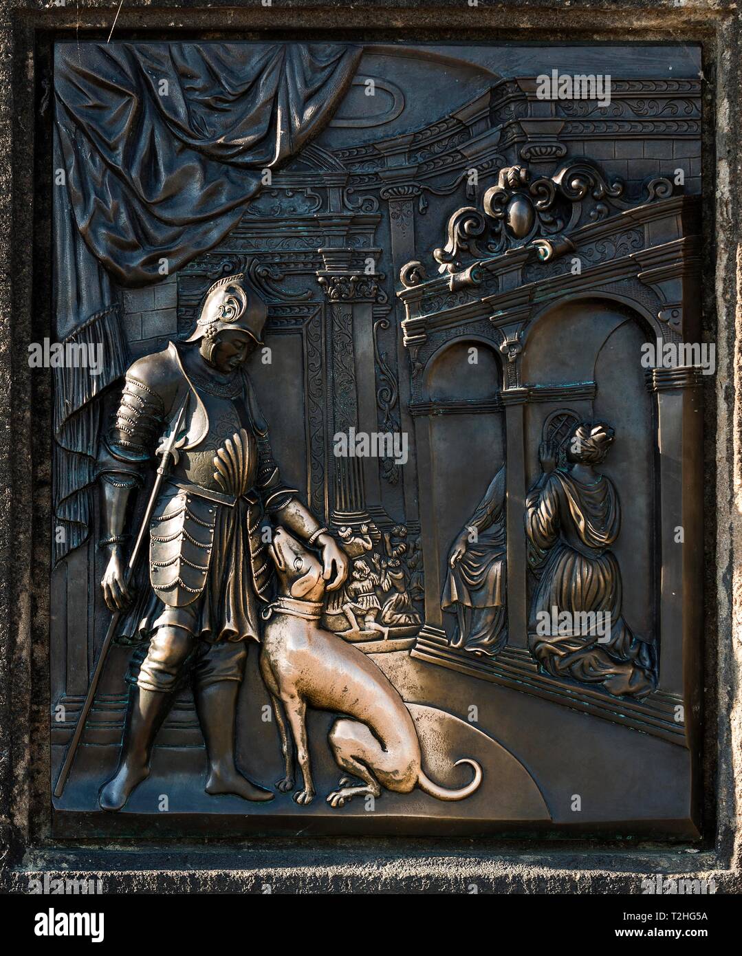 Dog relief at the statue of st john of nepomuk hires stock photography