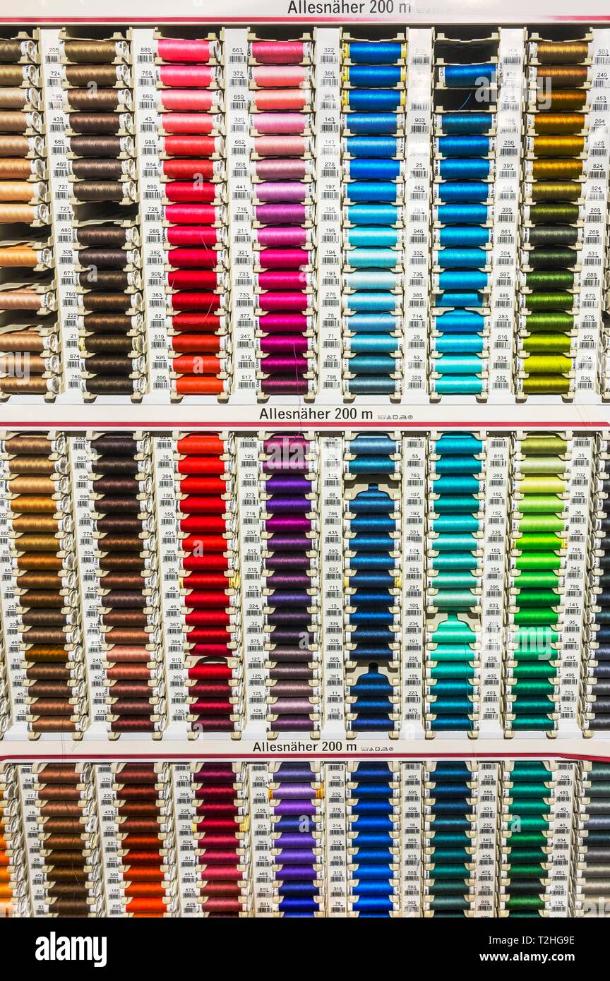 Colorful spools with sewing thread in many colors in a department store, Bavaria, Germany Stock Photo