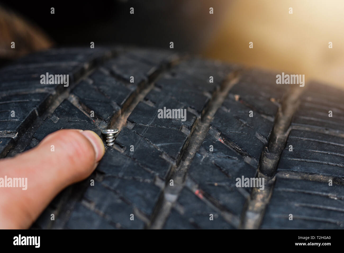 Close up tack in tire ,Flat tire The tire is leaking from the nail .a