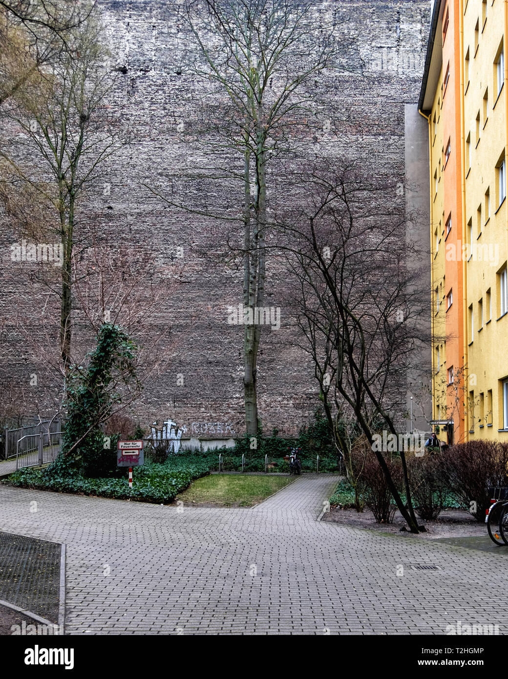 Inner courtyard of apartment building. Bright wall of new building and