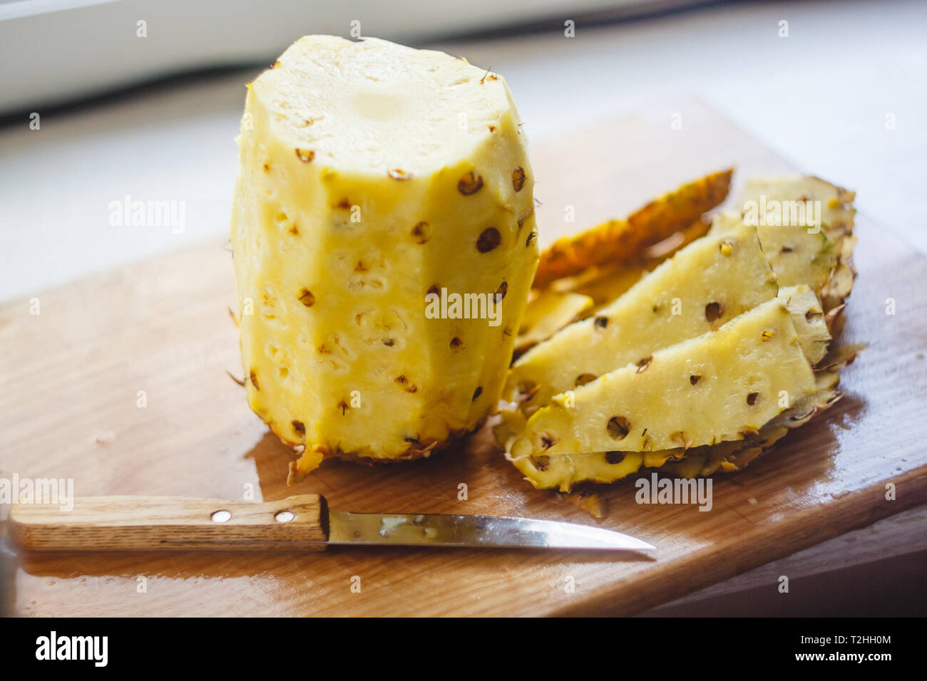 Pineapple cleaning, chunks, knife lie on the board Stock Photo Alamy