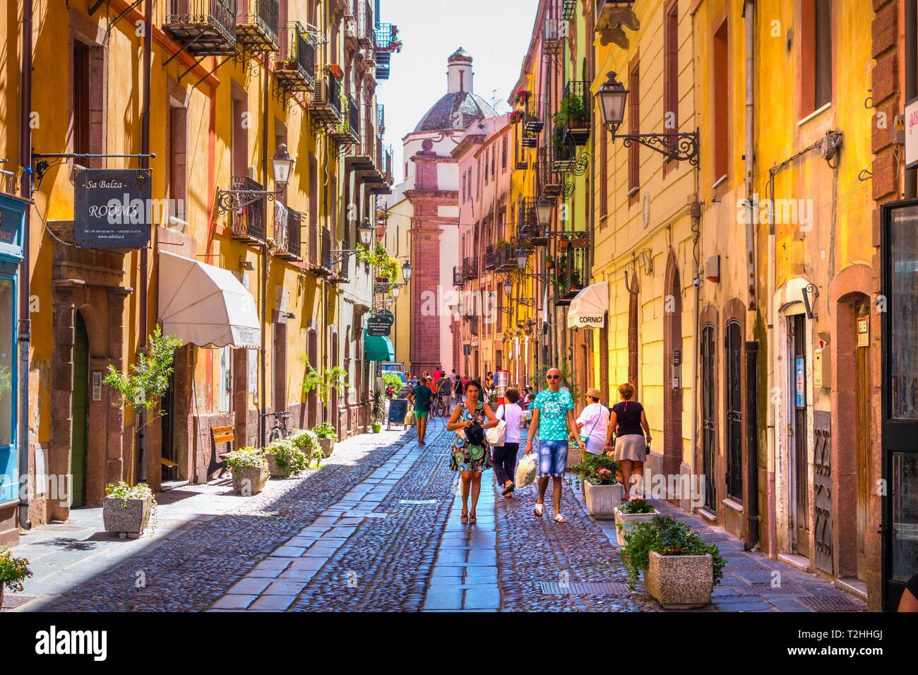 People walking along street in Bosa, Sardinia, Italy, Europe Stock Photo