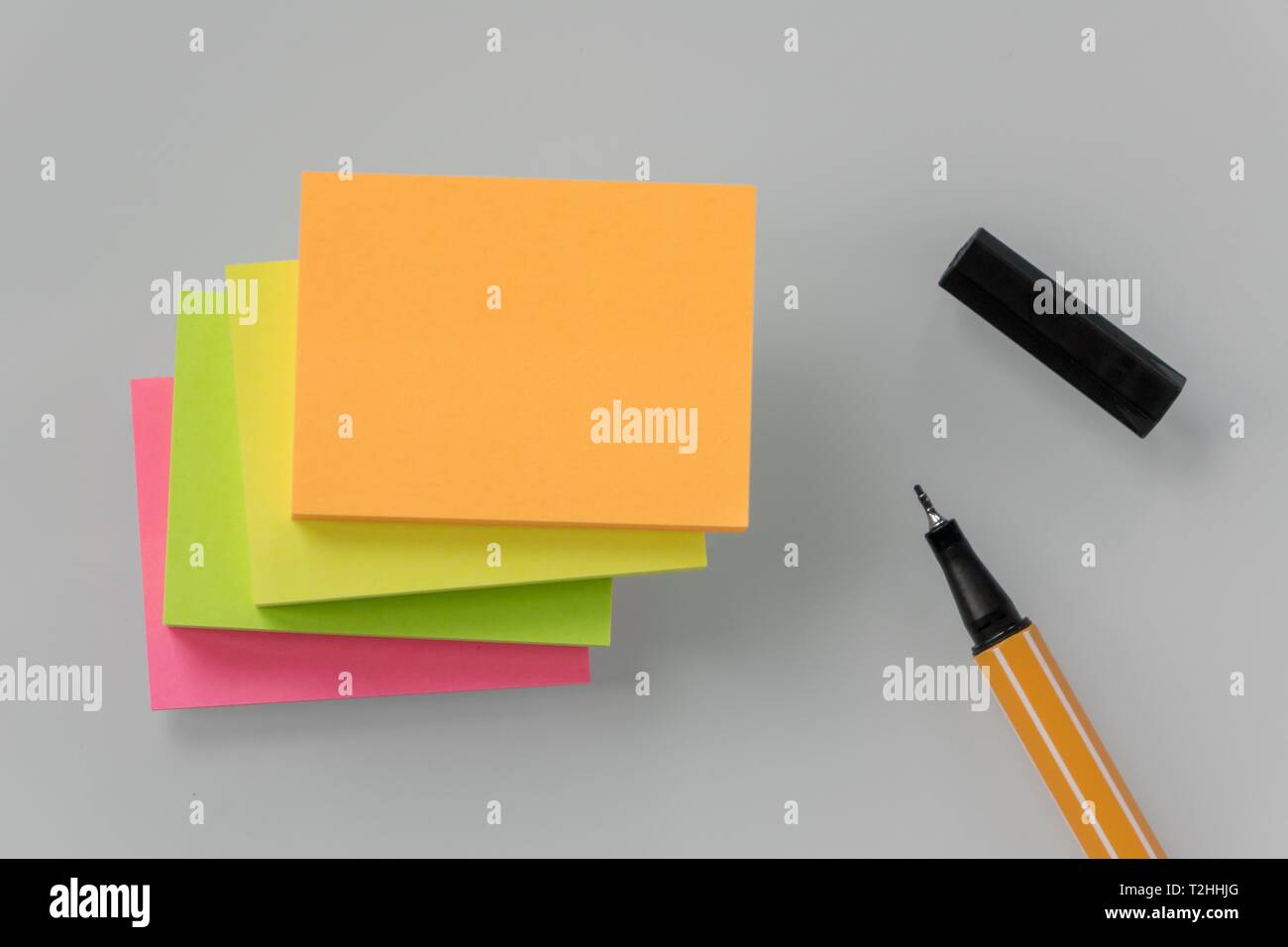 Post it stack, notepad, various colors, and black pen, Germany Stock Photo