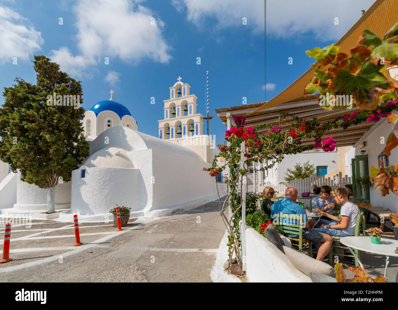 St. Epifanios Traditional Orthodox Church by restaurant in Akrotiri, Thira, Santorini, Cyclades Islands, Greece, Europe Stock Photo