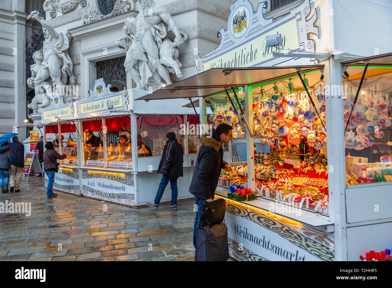Shoppers at Christmas market stalls in Michaelerplatz, Vienna, Austria, Europe Stock Photo