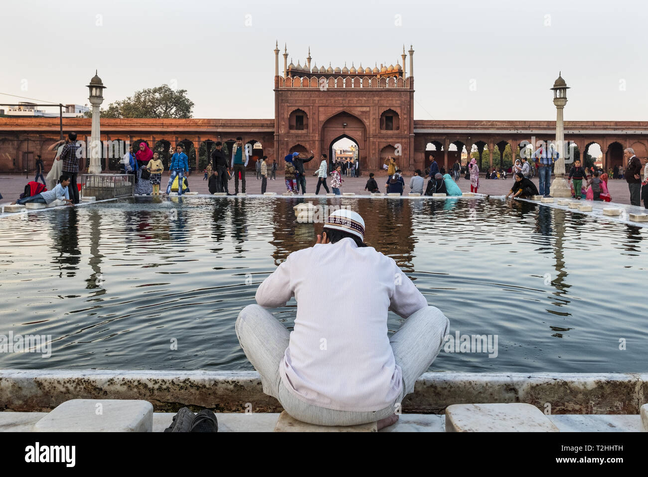 Muslim man washing hands and feet before prayer time, Jama Masjid, one of the largest mosques in India, South Asia Stock Photo