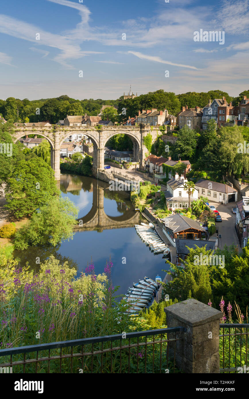 Rowing boats and viaduct over the River Nidd in lower Nidderdale on a mid-summer sunny day, Knaresborough, Borough of Harrogate, North Yorkshire, UK Stock Photo