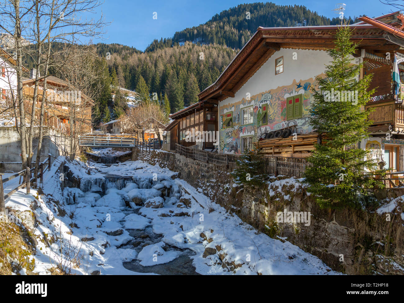 View of frozen river in Canazei town centre in winter, Val di Fassa, Trentino, Italy, Europe Stock Photo