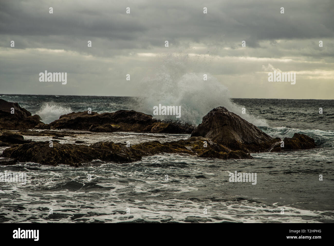 one wave breaking of the stone. Lanzarote island , bad weather in the spring Stock Photo