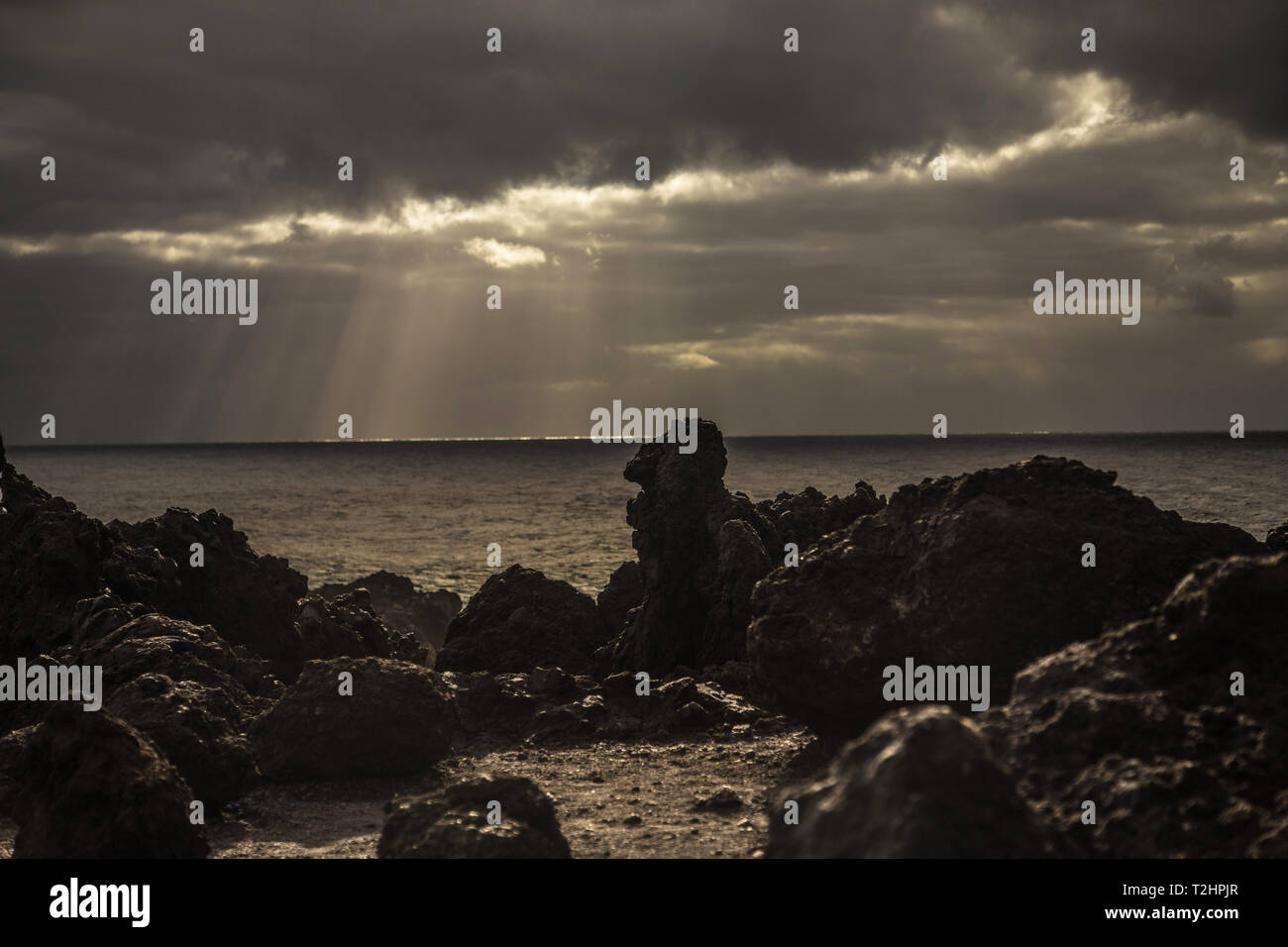 Sun rise on the ocean side, water and stones at the evening Stock Photo