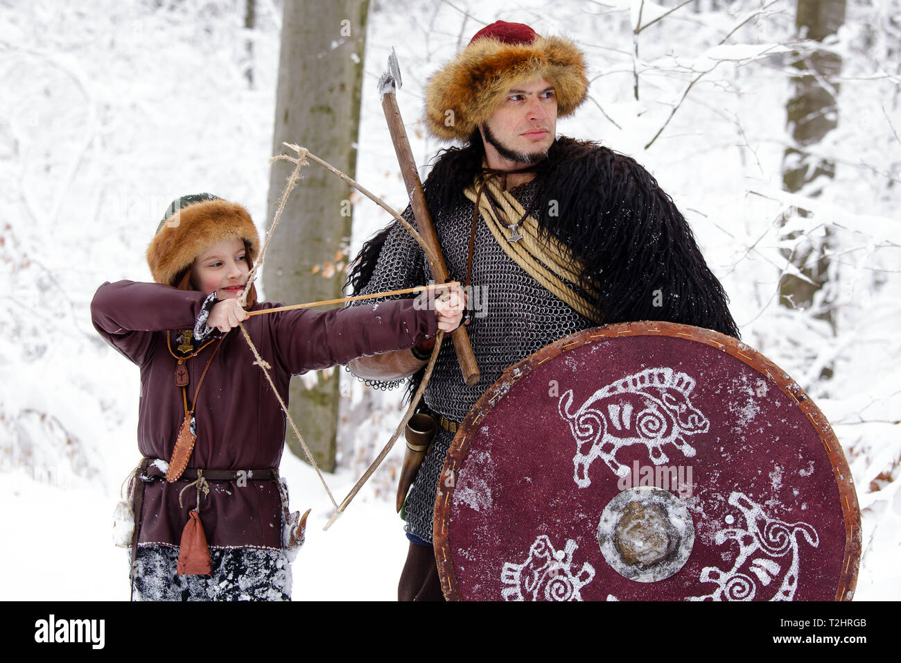 Viking warrior with chain mail leather spear walking in winter woods