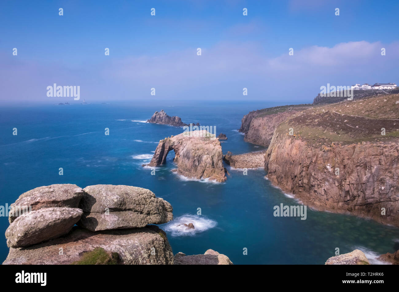 Dramatic cliffs, sea stacks and Enys Dodnan arch on the rugged north Atlantic coast, Lands End, Cornwall, UK Stock Photo