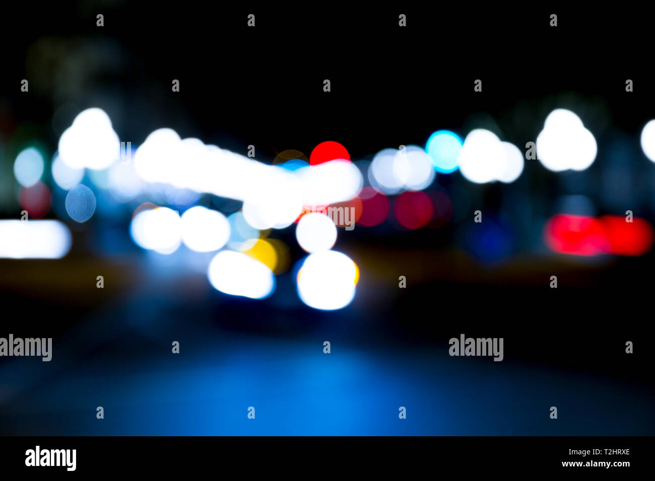 abstract traffic lights on urban street at night, abstract bokeh, blurred motion Stock Photo