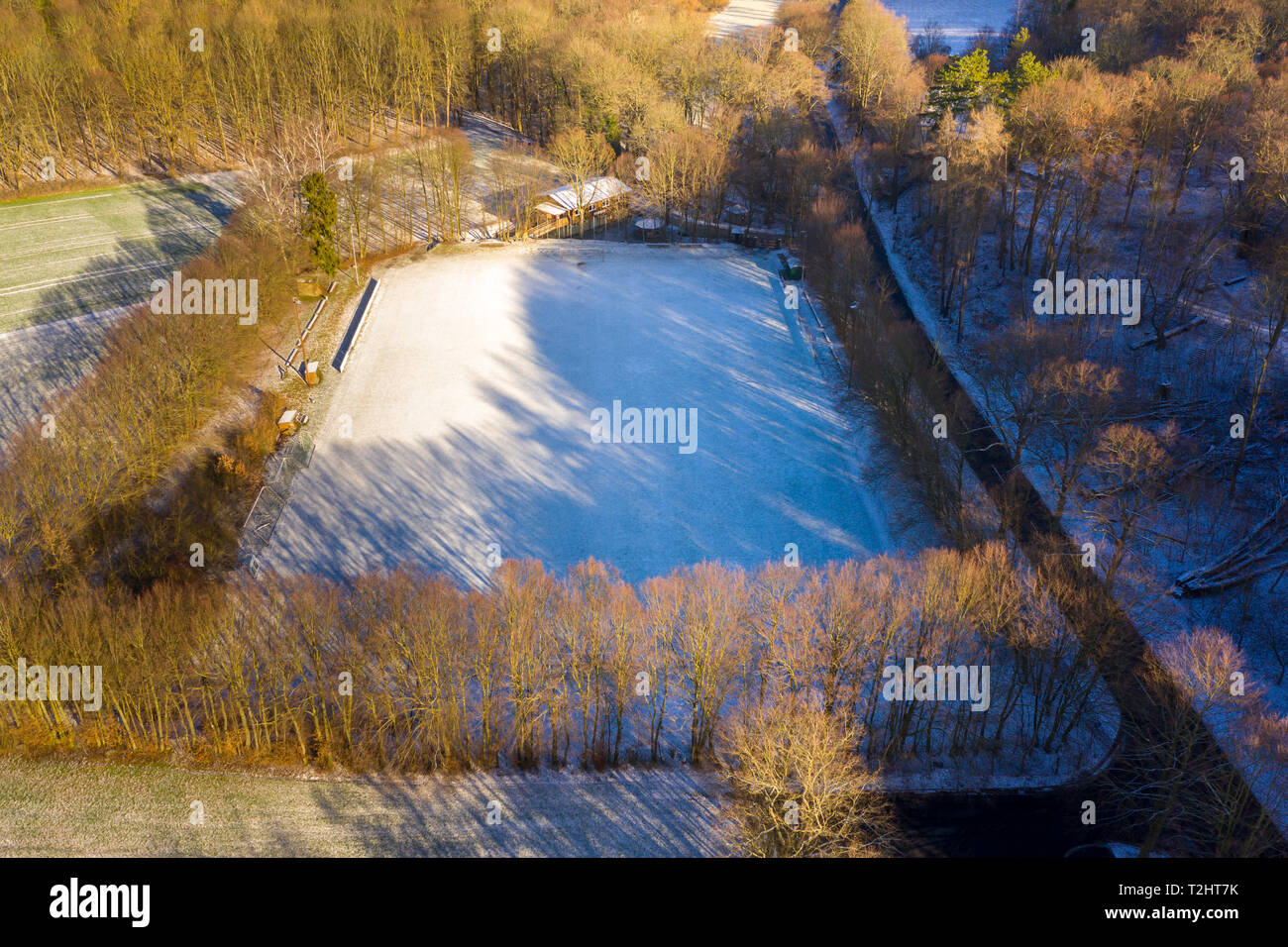 Aerial view of a football field of a district league team in a village with the first snow of the year, drone shot Stock Photo