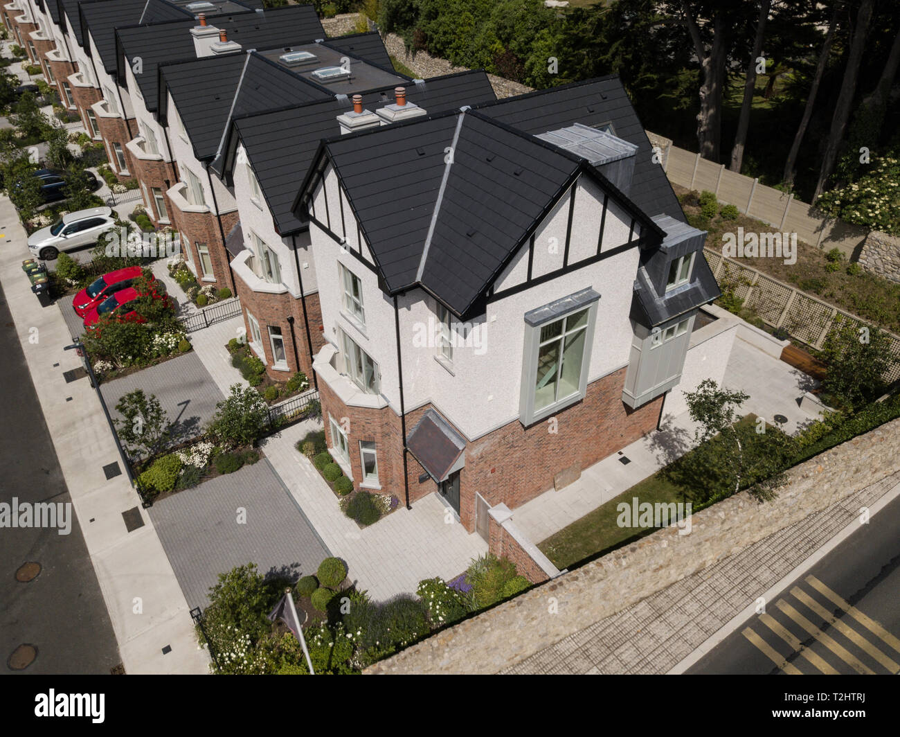 Mock Tudor homes shot by drone, showing the entire housing development and frontal elevation of the luxury homes Stock Photo