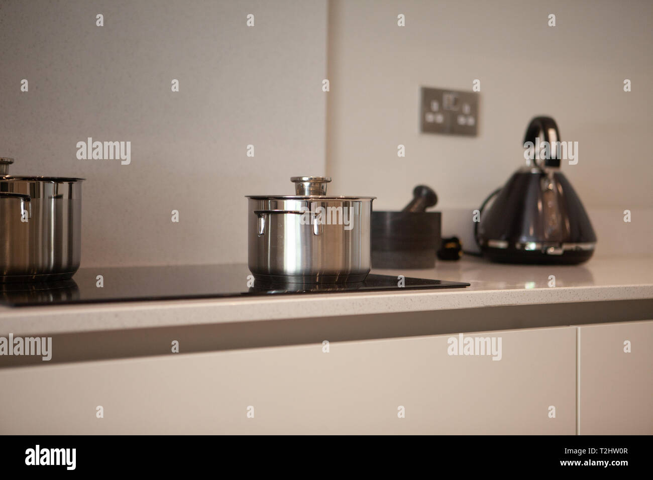 modern appliances and kitchen utensils on an induction hob in a modern kitchen. Stock Photo