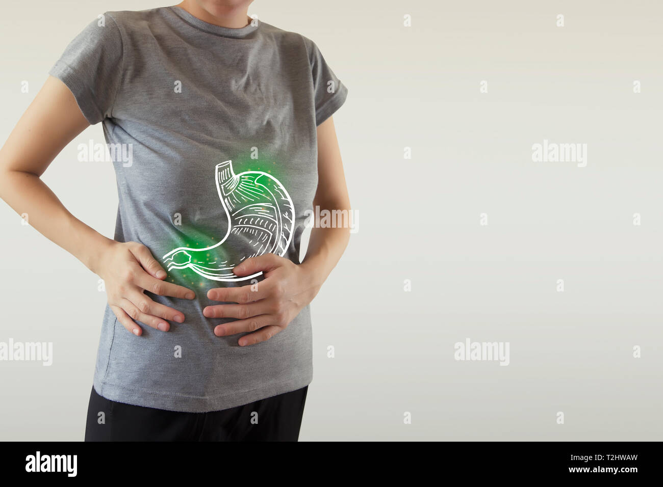 Digital composite of highlighted green stomach of woman with infection