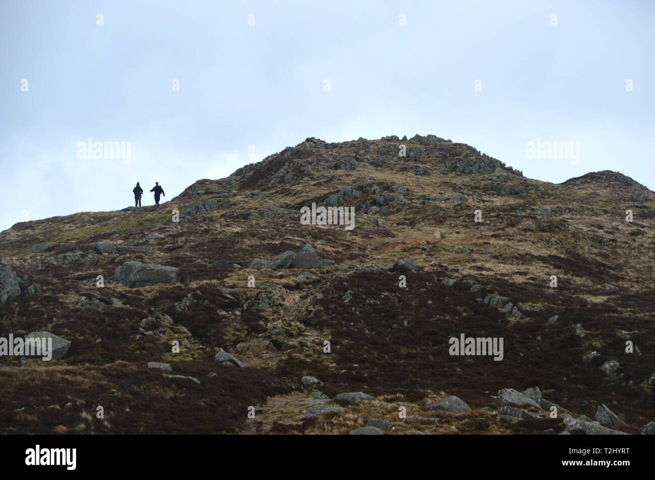 A Couple of Fellwalkers on the Summit of the Wainwright Sheffield Pike in the Lake District National Park, Cumbria, UK. Stock Photo