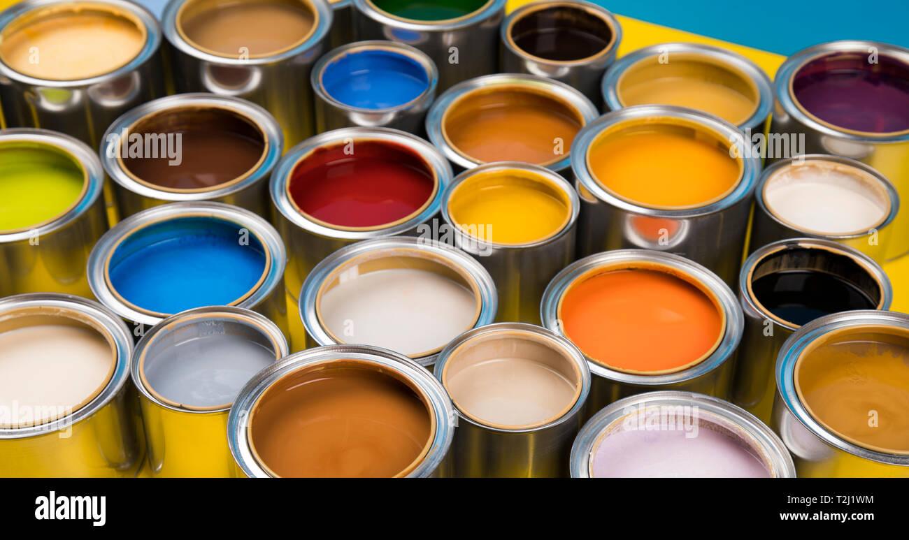 Open cans of paint, blue background Stock Photo Alamy