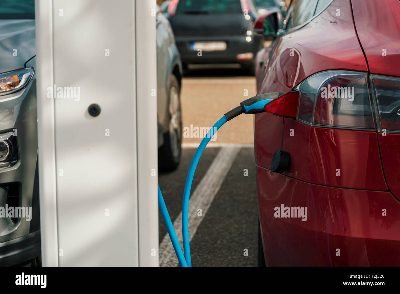 electric car connected to a recharging pole. concept for environmental awareness. Stock Photo