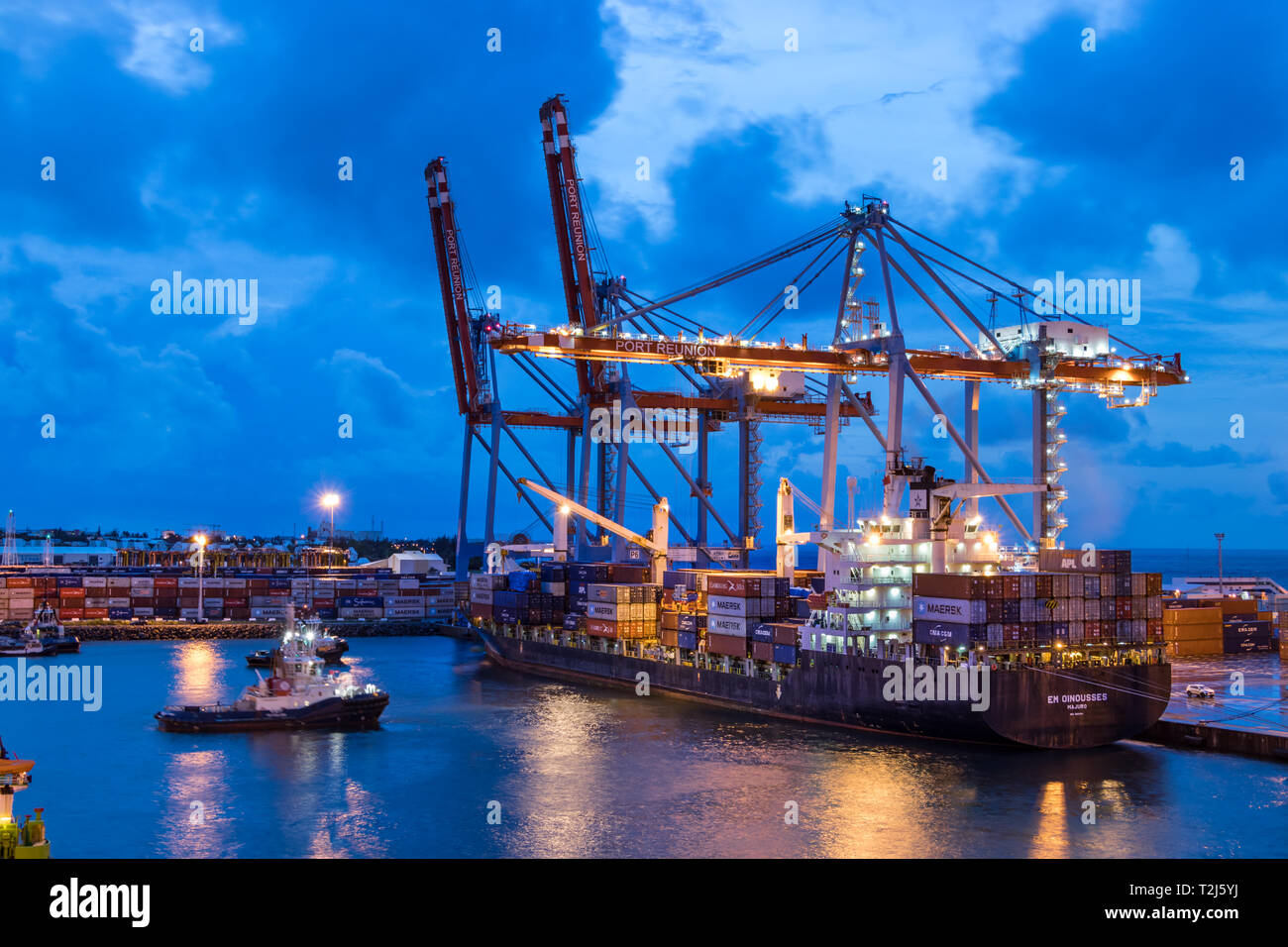 Saint Denis, Reunion Island - January 26th, 2019: Cranes and cargo  containers ships at the Port of Saint Denis in Reunion Island in the  evening. (Fran Stock Photo - Alamy