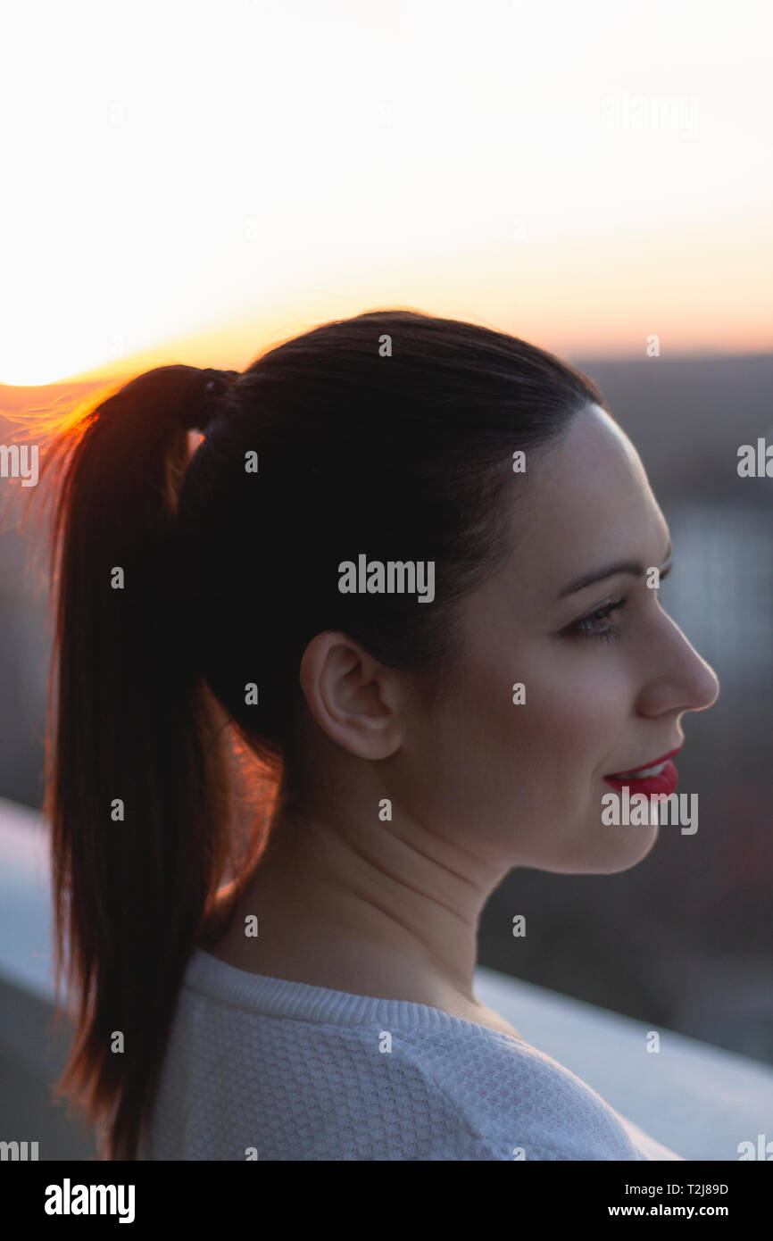 Woman watching sunset balcony hi-res stock photography and images - Alamy