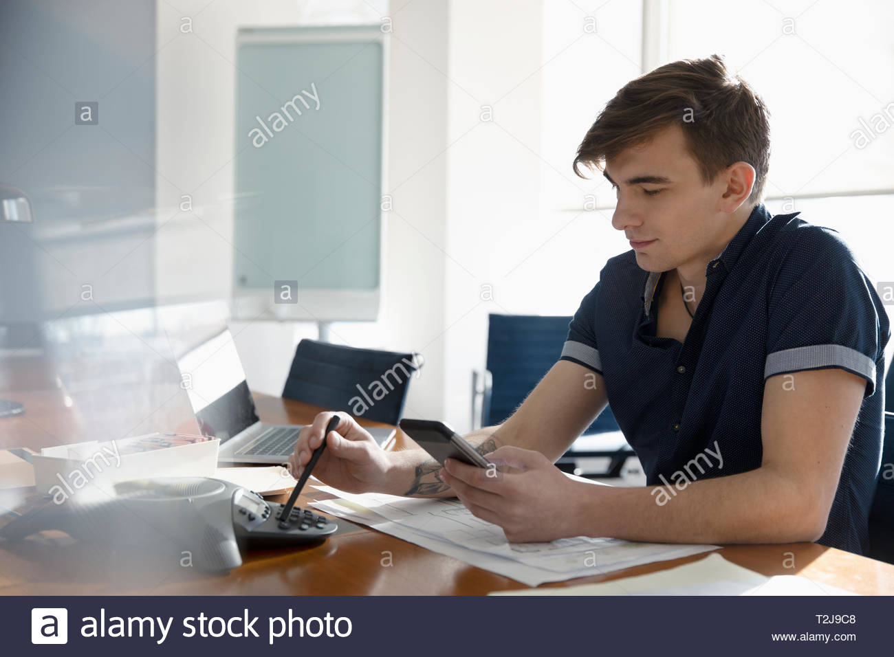 Businessman preparing for conference call in conference room Stock Photo