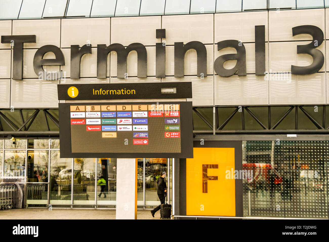 LONDON HEATHROW AIRPORT, ENGLAND - FEBRUARY 2019:  Airline logos showing on an electronic display screen outside London Heathrow Airport Terminal 3 Stock Photo