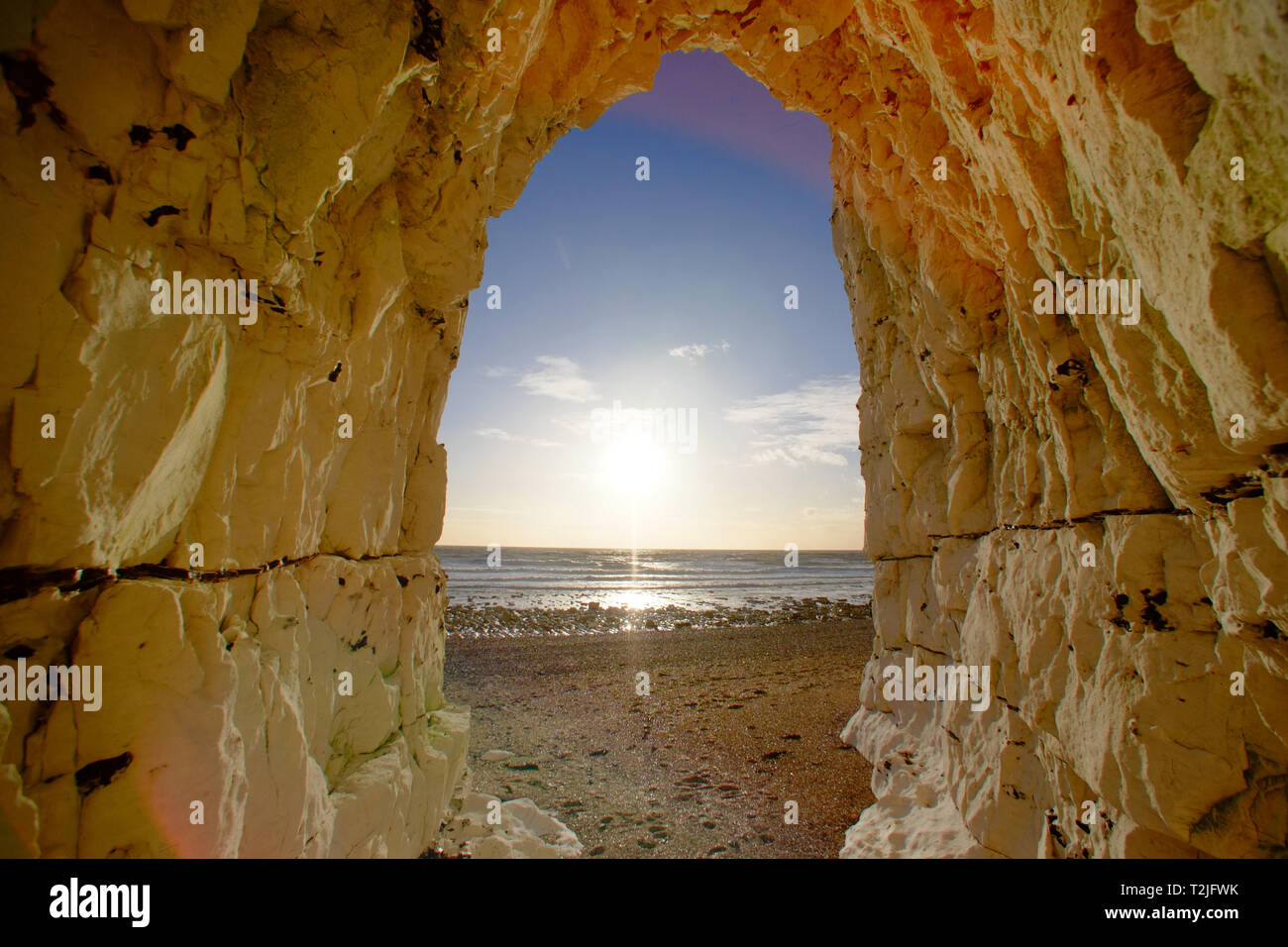 View of a sunset from a cave in the chalk cliffs near Beachy Head, Eastbourne, East Sussex, UK Stock Photo