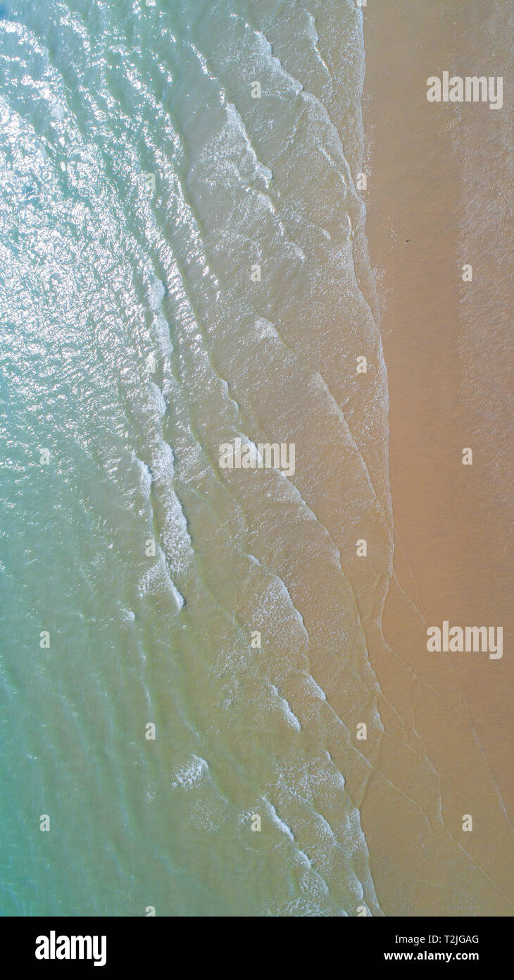 Gentle surf laps a sandy beach, seen from above, Sussex, UK Stock Photo