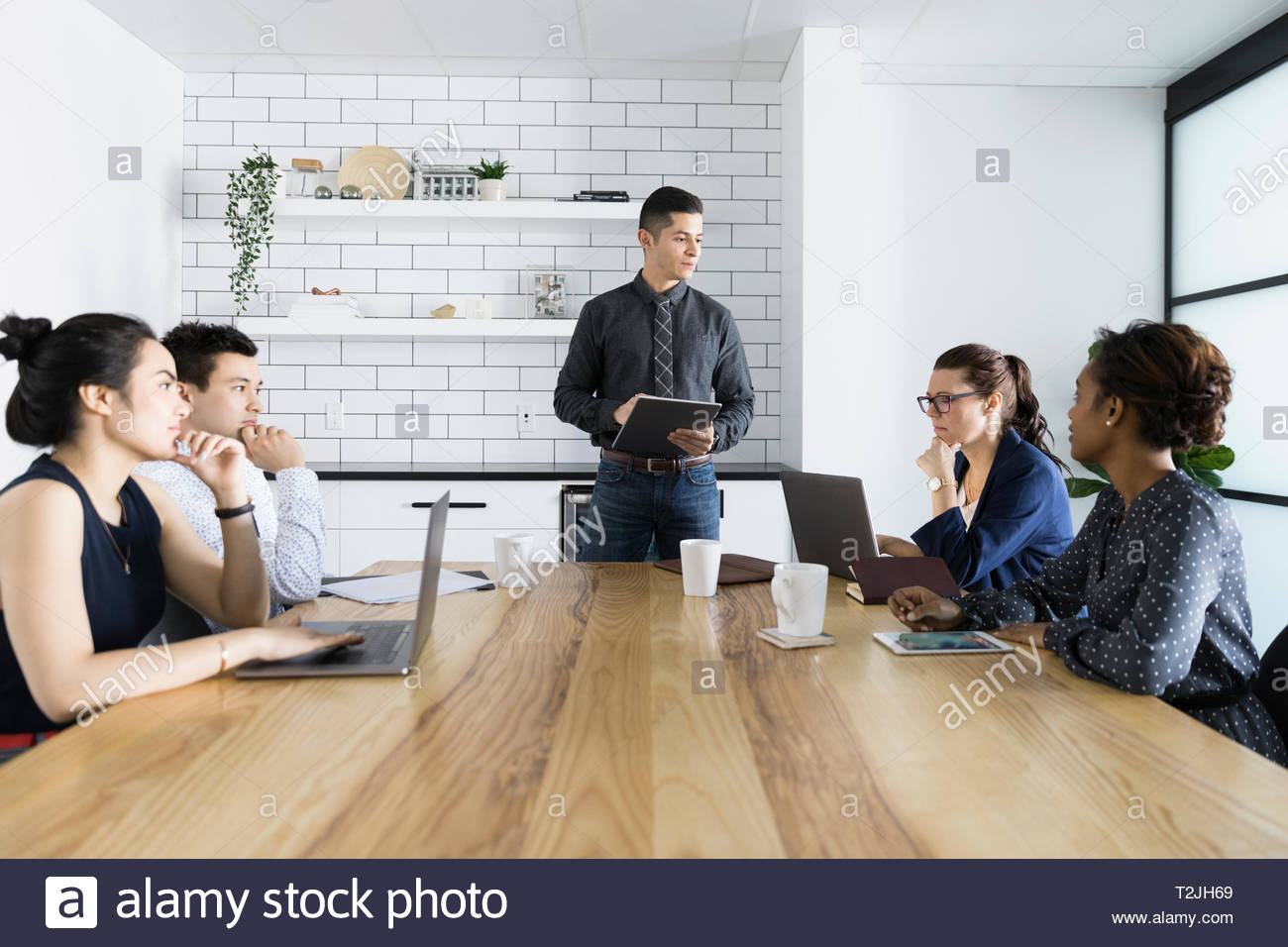 Businessman leading conference room meeting Stock Photo Alamy
