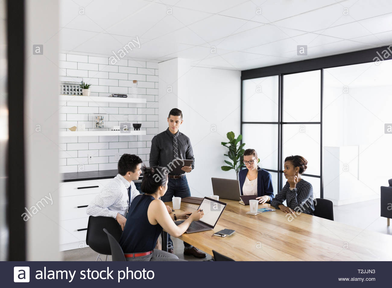 Businessman leading conference room meeting Stock Photo Alamy