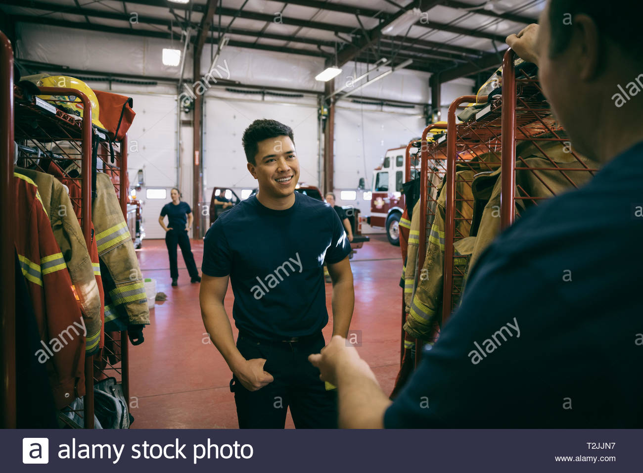 Firefighters talking in fire station Stock Photo - Alamy