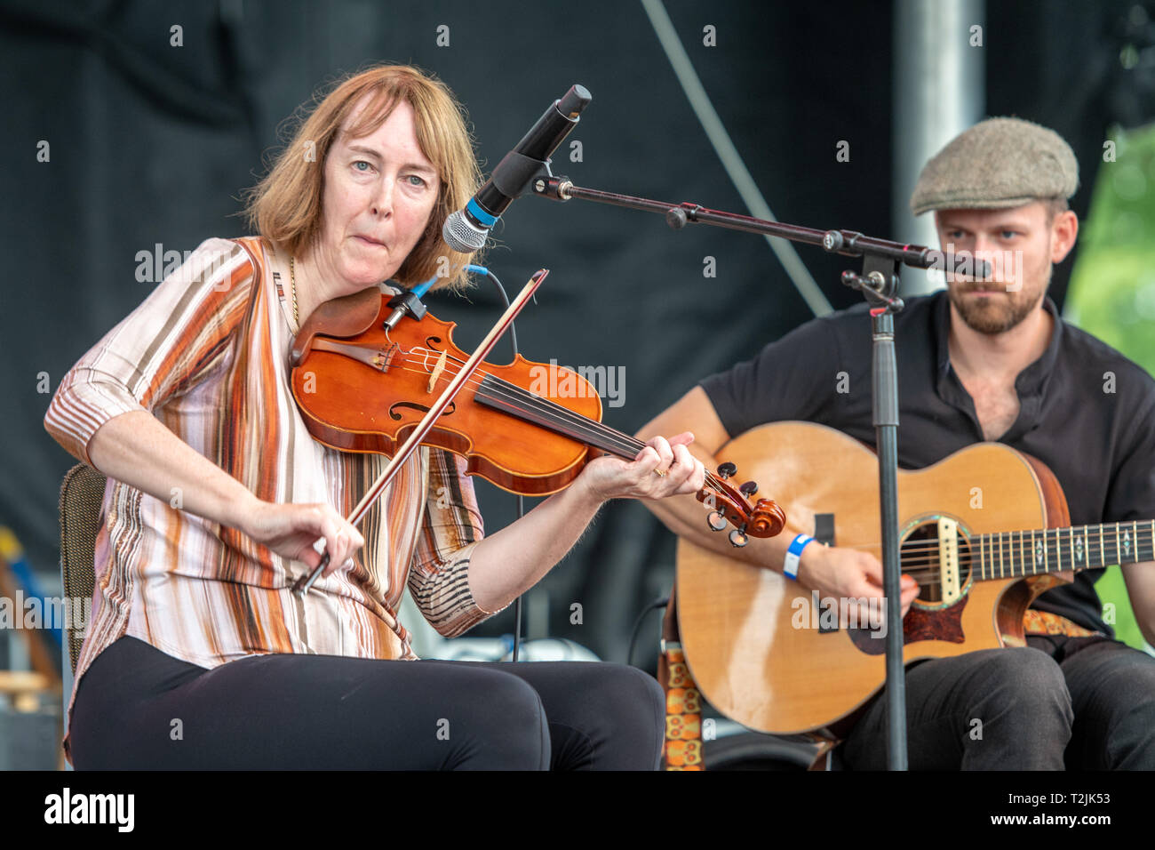 Irish musicians Liz Carroll & Jake Charron playing violin and guitar on stage at National Folk Festival in Salisbury, MD Stock Photo