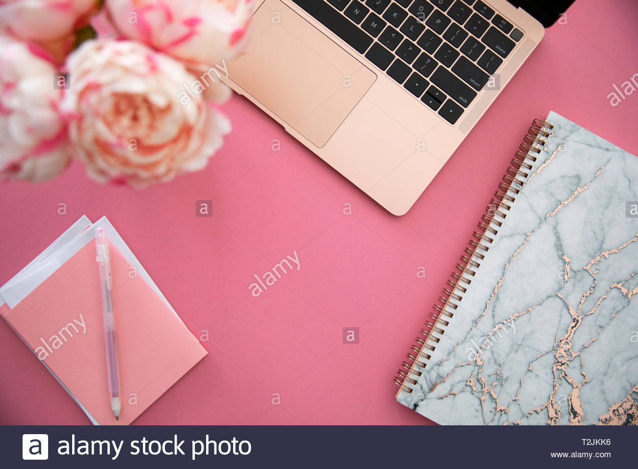 Laptop, notebook and stationery on pink background Stock Photo Alamy