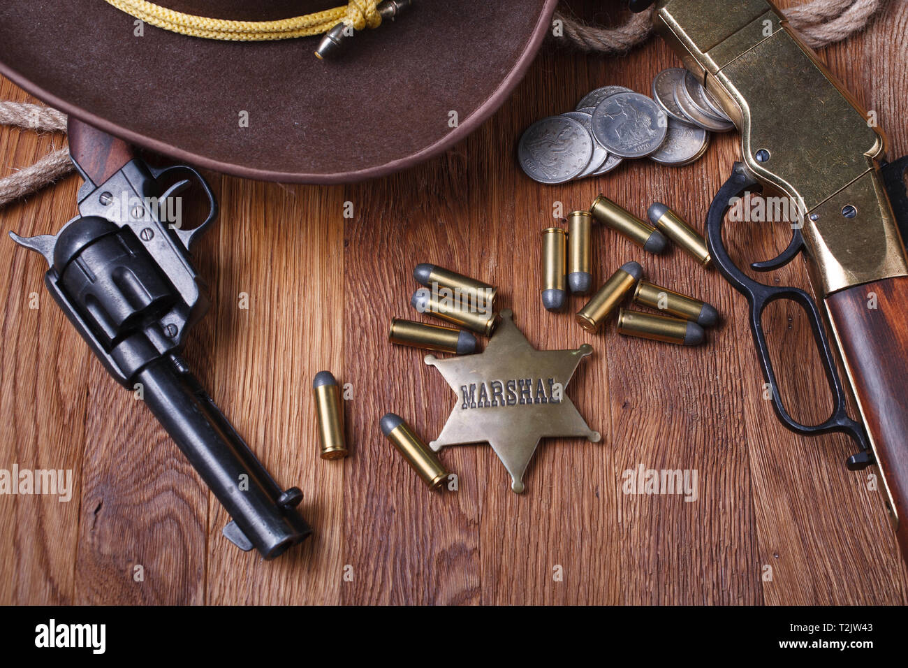 Wild west gun, ammunition and U.S. Marshal Badge on wooden table Stock Photo