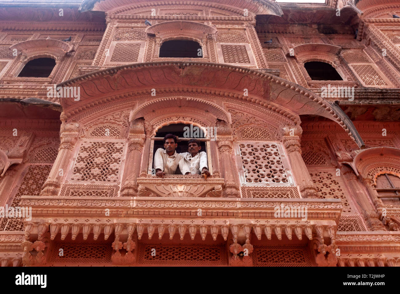 Two locals from an ornate stone window in Mehrangarh, Mehran Fort ...
