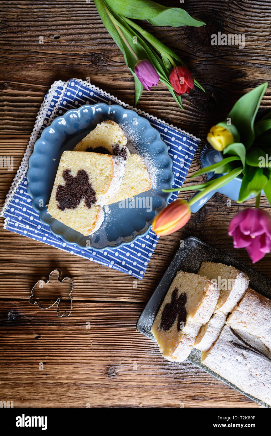 Sweet vanilla pound cake with Easter bunny inside, sprinkled with powdered sugar Stock Photo